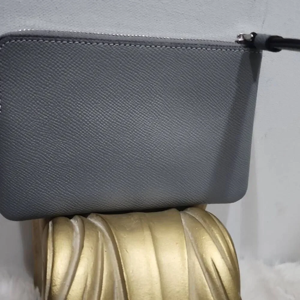 Coach Corner Zip Wristlet in a grey crossgrain leather.
